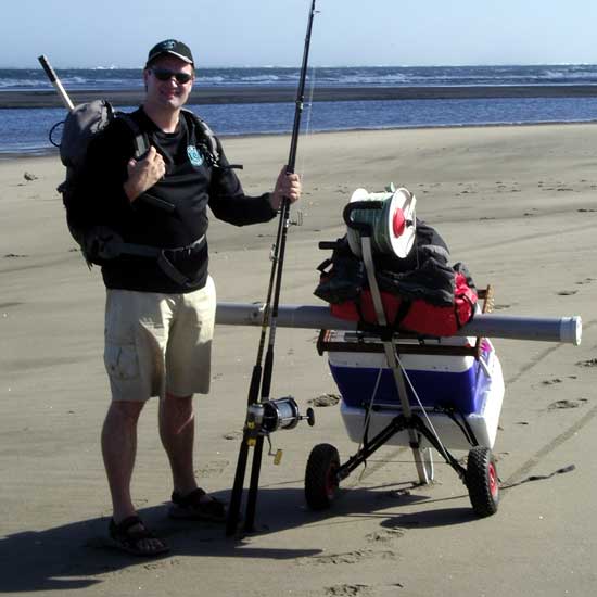 Beach cart loaded with fishing tackle, two cooler bins and kite fishing rigs